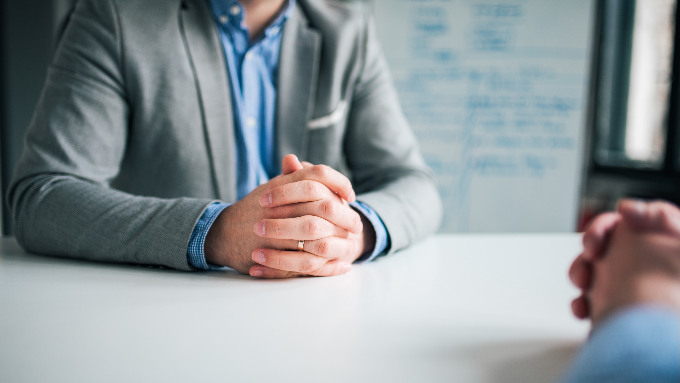 Man with folded hands talking about Mental Health Assessment in the company